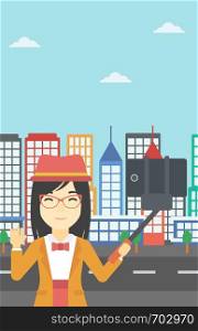 An asian woman making selfie with a selfie-stick. An asian woman taking photo with cellphone and waving on a city background. Vector flat design illustration. Vertical layout.. Woman making selfie vector illustration.