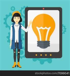 An asian woman pointing at a big tablet computer with a light bulb on a screen on a blue background with cogwheels vector flat design illustration. Square layout.. Woman pointing at tablet computer with light bulb on screen.
