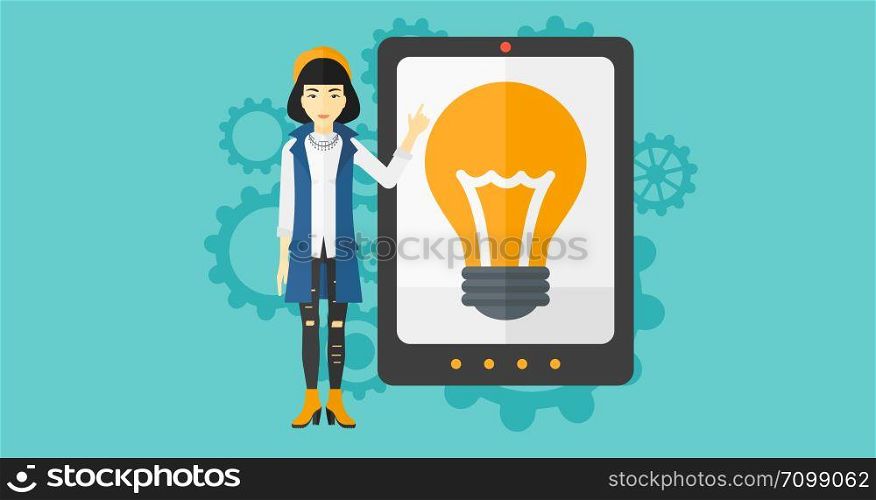 An asian woman pointing at a big tablet computer with a light bulb on a screen on a blue background with cogwheels vector flat design illustration. Horizontal layout.. Woman pointing at tablet computer with light bulb on screen.