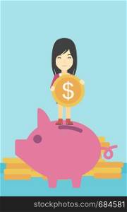 An asian young business woman saving her money by putting a coin in a big piggy bank on a background of stacks of gold coins. Vector flat design illustration. Vertical layout.. Business woman putting coin in piggy bank.