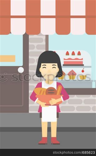 An asian young female baker holding basket with bakery products. Female baker standing in front of bakery. Baker with bowl full of bread. Vector flat design illustration. Vertical layout.. Baker holding basket with bakery products.