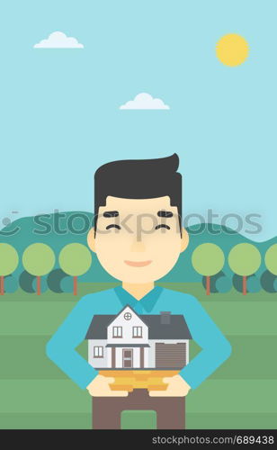 An asian young man holding house model in hands on the background of mountains. Real estate agent with house model. Vector flat design illustration. Vertical layout.. Man holding house model vector illustration.