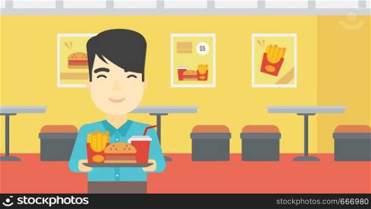 An asian young man holding tray full of junk food on a cafe background. Smiling man in fast food restaurant. Man having lunch in a fast food restaurant. Vector flat design illustration. Horizontal layout.. Man with tray full of fast food.