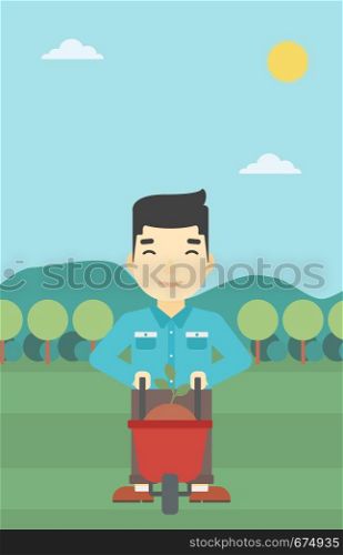 An asian young man standing with a plant and soil in a wheelbarrow on the background of mountain landscape. Vector flat design illustration. Vertical layout.. Man with plant and wheelbarrow.
