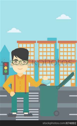 An asian young man throwing away a garbage in a green trash in the city. Man throwing away trash. Eco-friendly man throwing trash. Vector flat design illustration. Vertical layout.. Man throwing away trash vector illustration.