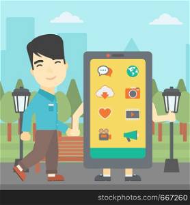 An asian young man walking with a big smartphone. Man and big smartphone in the park. Man holding the hand of smartphone. Smartphone addiction. Vector flat design illustration. Square layout.. Man walking with big smartphone.