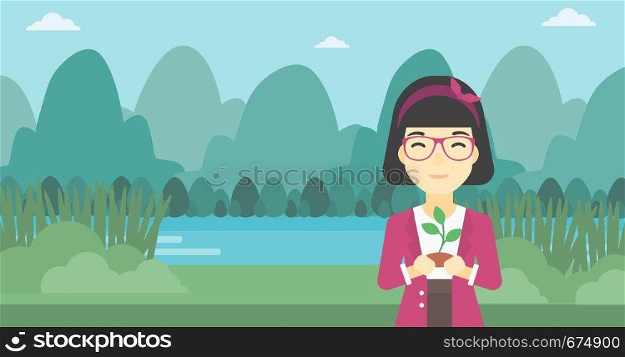 An asian young woman holding in hands a small plant in soil on the background of landscape with mountains and river. Vector flat design illustration. Horizontal layout.. Woman holding plant vector illustration.