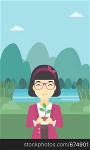 An asian young woman holding in hands a small plant in soil on the background of landscape with mountains and river. Vector flat design illustration. Vertical layout.. Woman holding plant vector illustration.