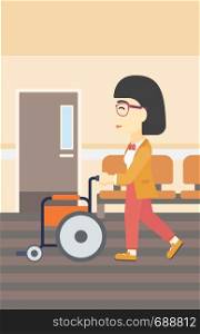 An asian young woman pushing empty wheelchair on the background of hospital corridor. Vector flat design illustration. Vertical layout.. Woman pushing wheelchair vector illustration.