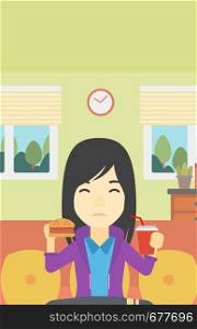 An asian young woman sitting on a sofa while eating hamburger and drinking soda on the background of living room. Vector flat design illustration. Vertical layout.. Woman eating hamburger vector illustration.