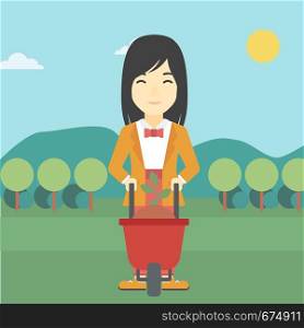 An asian young woman standing with a plant and soil in a wheelbarrow on the background of mountain landscape. Vector flat design illustration. Square layout.. Woman with plant and wheelbarrow.