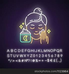 Applying night cream neon light icon. Skin care procedure. Facial treatment. Sleeping cream. Dermatology, cosmetics. Glowing sign with alphabet, numbers and symbols. Vector isolated illustration