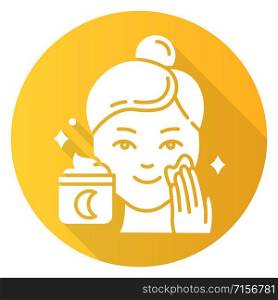 Applying night cream yellow flat design long shadow glyph icon. Skin care procedure. Facial treatment product. Sleeping cream for evening beauty routine. Vector silhouette illustration