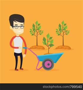 Asian gardener with wheelbarrow standing on the background of newly planted trees. Young gardener pushing wheelbarrow with tree and dirt in the park. Vector flat design illustration. Square layout.. Man pushing wheelbarrow with plant.