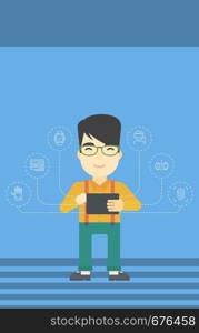 Asian happy student holding tablet computer. Young man working on tablet computer and some icons connected to the device on a light blue background. Vector flat design illustration. Vertical layout.. Student working on tablet computer.
