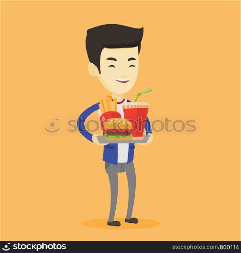 Asian man holding tray with fast food. Young man having a lunch in a fast food restaurant. Happy man with fast food. Unhealthy nutrition concept. Vector flat design illustration. Square layout.. Man holding tray full of fast food.