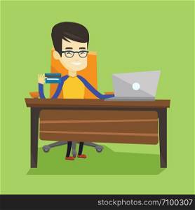 Asian man sitting at the table with laptop and holding credit card in hand. Man using laptop for online shopping. Young man shopping online at home. Vector flat design illustration. Square layout.. Man shopping online vector illustration.