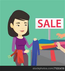 Asian woman choosing clothes in shop on sale. Happy female customer buying clothes at store on sale. Young girl shopping in clothes shop on sale. Vector flat design illustration. Square layout.. Young woman choosing clothes in shop on sale.