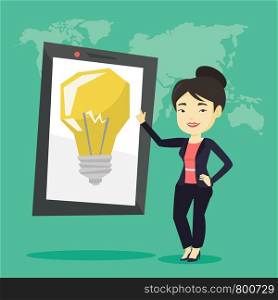 Asian woman pointing at a big tablet computer with a light bulb on a screen. Busineswoman standing near tablet computer on the background with world map. Vector flat design illustration. Square layout. Woman pointing at big tablet computer.