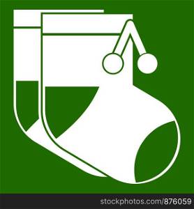 Baby socks icon white isolated on green background. Vector illustration. Baby socks icon green