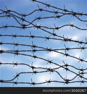 Barbed Wire Against Sky. Metal barbed wire against blurry sky background.