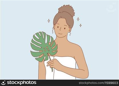 Beauty, makeup, ecology, advertising concept. Young happy smiling african american woman girl cartoon character standing in towel and green leaf looking at camera. Bio or eco creams and oils promotion. Beauty, makeup, ecology, advertising concept