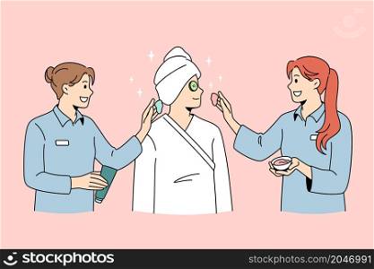 Beauty spa and cosmetology concept. Smiling women dermatologists wellness workers standing taking care of female client skin making beauty treatments vector illustration . Beauty spa and cosmetology concept.