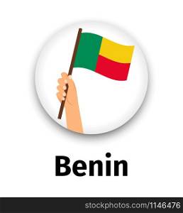 Benin flag in hand, round icon with shadow isolated on white. Human hand holding flag, vector illustration. Benin flag in hand, round icon