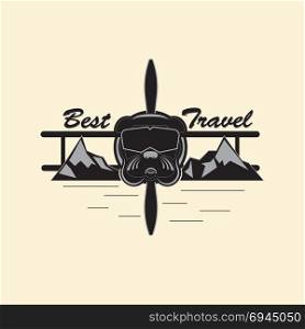 Best Travel Logo. Logo indicating extreme rest and travel. Bulldog in the form of an extreme pilot, in a mountainous area. Vector illustration in gray tones.