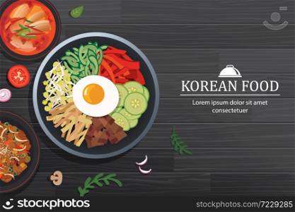 Bibimbap in the bowl on black wood table top view. Korea food background.