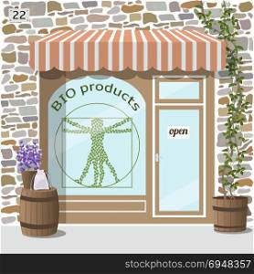 Bio products shop. Organic products store.. Bio products shop building. Facade of stone. Plant and barrel with lavender on it at the fore. Vector illustration EPS10