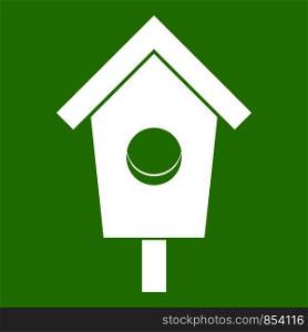 Birdhouse icon white isolated on green background. Vector illustration. Birdhouse icon green