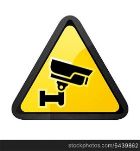Black surveillance camera. Black surveillance camera on a yellow triangular shape