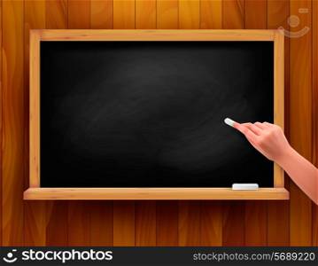 Blackboard with hand on wooden background