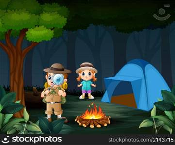 Boy explorer with magnifying glass with a girl in the forest