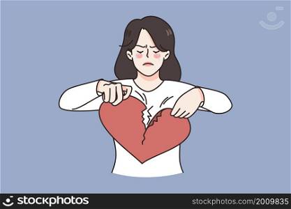 Breaking up and Broken heart concept. Young sad unhappy disappointed crying woman standing and breaking huge red heart into pieces vector illustration . Breaking up and Broken heart concept