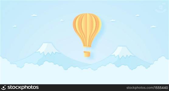 bright hot air balloon flying over mountain with blue sky, paper art style