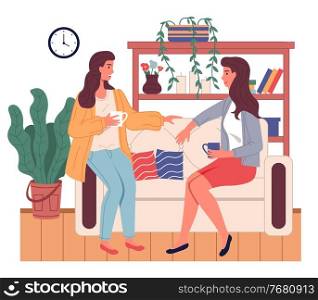Brunette women girls sitting at sofa and talking. Friends relaxing at home with cup of tea or coffee. Happy girls spending leisure time at home. Sisters talking, relaxing at couch sofa in living room. Brunette women girls sitting at sofa and talking, friends relaxing at home with cup of tea or coffee