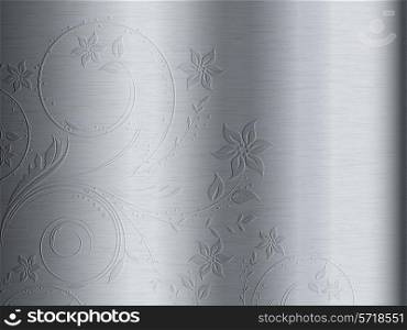 Brushed metal texture background with floral design embossed on it. Brushed metal