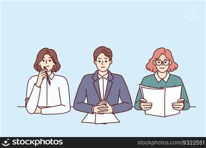Business people from recruiting company with skeptical expression are conducting interview sitting at table in office. Man and two women work as HR managers and participate in recruiting processes. Business people from recruiting company conducting interview sitting at table in office