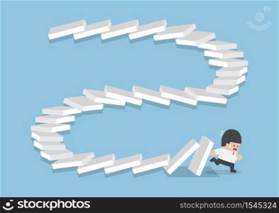 Businessman escaping from falling dominos, domino effect, bankruptcy, business crisis concept