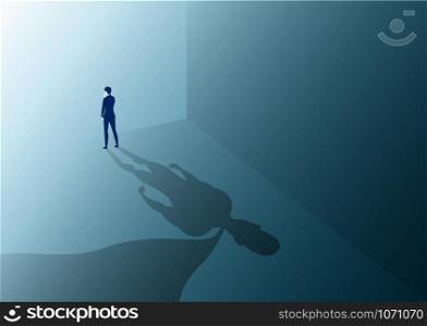 businessman looking to way success with a superhero with cape shadow on the wall. Ambition and business success concept. Leadership hero power, motivation and inner strength symbol