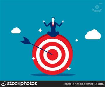 Businessman meditate sitting and focusing on big archer target. Stay focused and concentrate on business objective