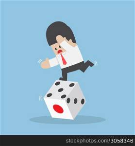 Businessman standing on unstable dice, business risk and luck concept