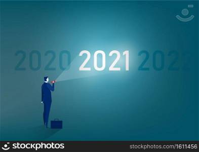 businessman stands with a flashlight to 2021 target cocept  