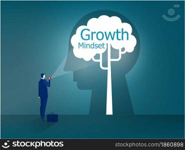 Businessman stands with a flashlight to growth mindset on head human concept vector