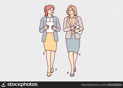 Businesswomen walking together talking discussing business ideas. Female employees with documents or paperwork in hands walk chatting. Vector illustration. . Businesswomen walk talking in office 