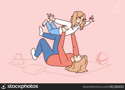 Caring mother lying on floor lifts laughing daughter enjoying playing with child on long-awaited day off. Carefree Caucasian family from mom self raising daughter or babysitting woman. Caring mother lying on floor lifts laughing daughter enjoying playing with child