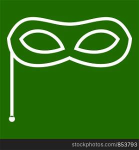 Carnival mask icon white isolated on green background. Vector illustration. Carnival mask icon green