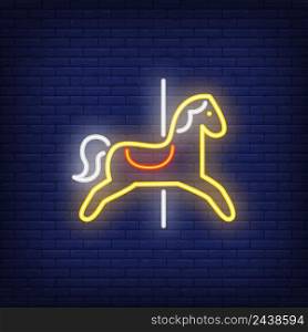 Carousel horse neon sign. Yellow animal seat on dark blue brick wall. Night bright advertisement. Vector illustration in neon style for amusement park and leisure